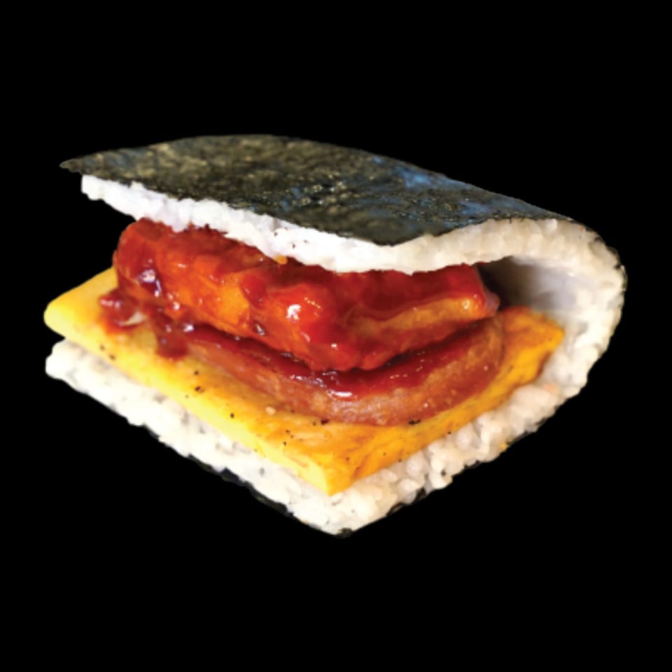 Okinawa onigiri with rice, spam, egg, and a red sauce, wrapped in nori.